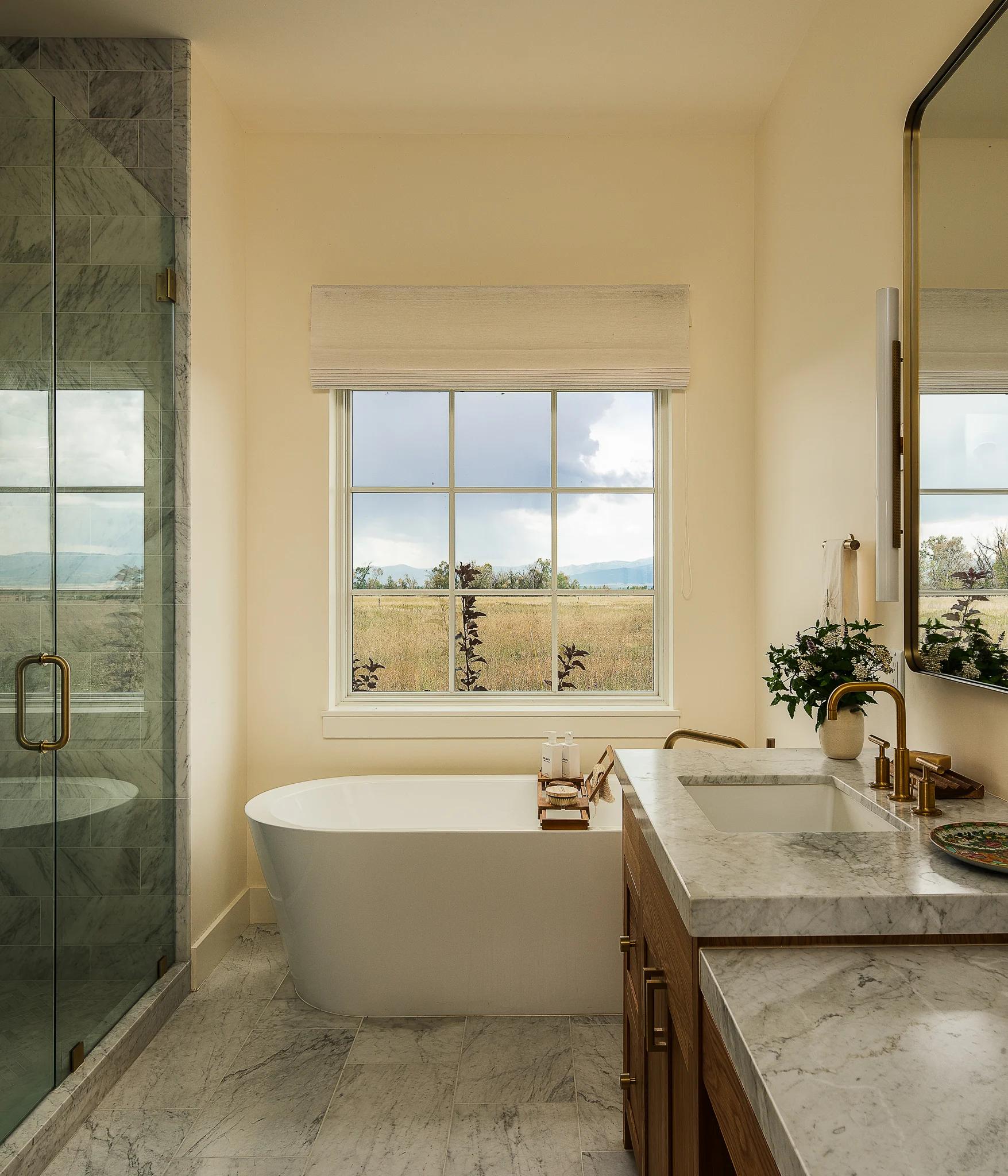 Spa bathroom with a marble soaking tub and mountain views — interior design photography Driggs Idaho, WTG Architects